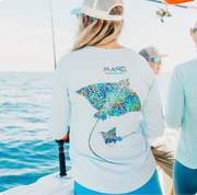 Woman on the water wearing a MANG Daze Rays performance longsleeve shirt