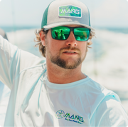 Close-up shot of man in MANG Apparel riding a boat