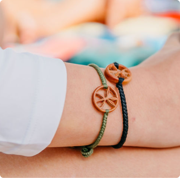 Two MANG woven bracelets wrapper around a woman's wrist