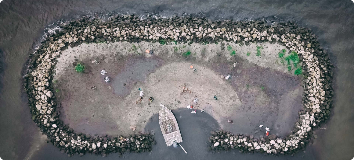 aerial view of small rock protected island accessible by boat prepared to plant mangroves by MANG volunteers in Florida 